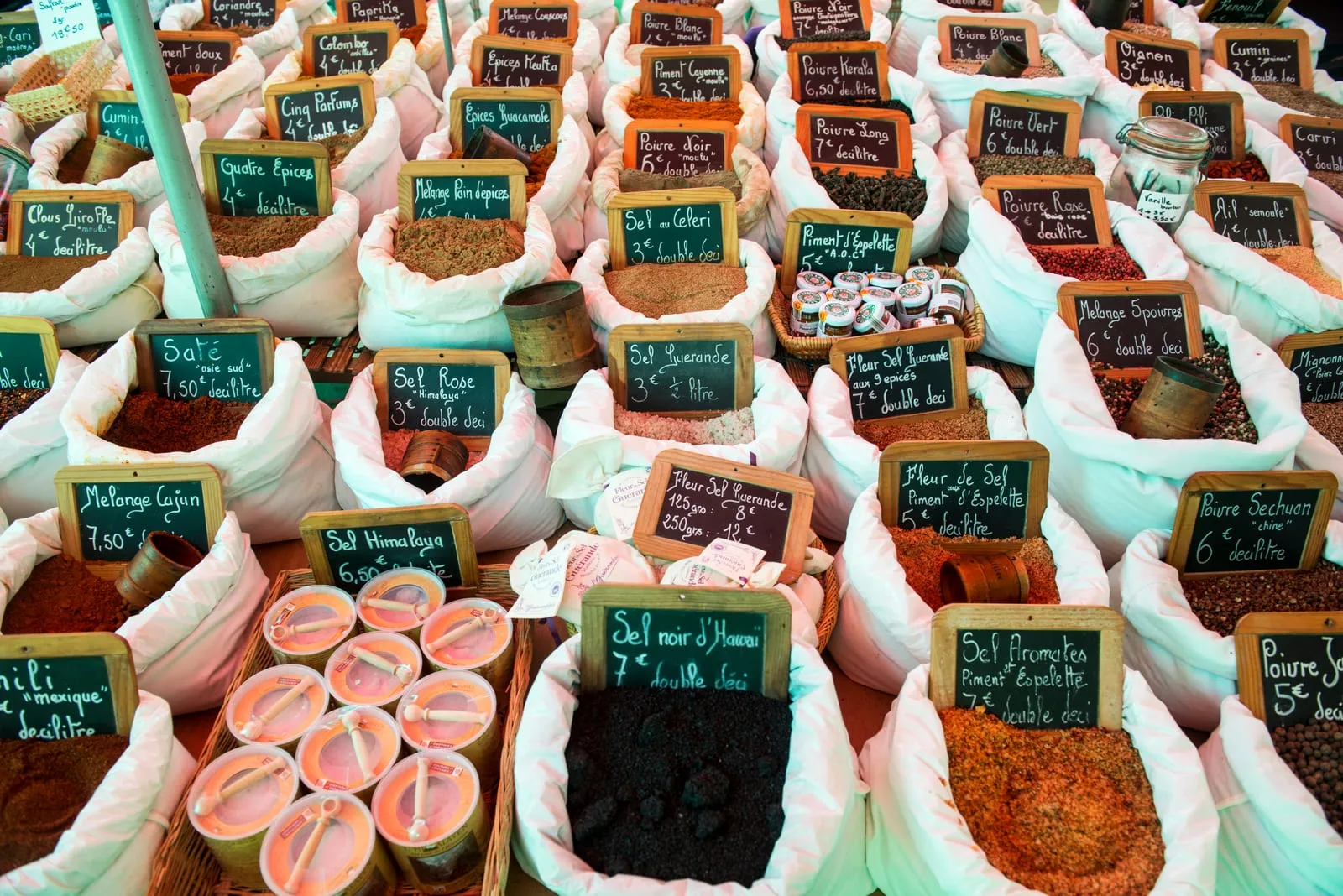 A market stall of spices and salts, under the plane trees