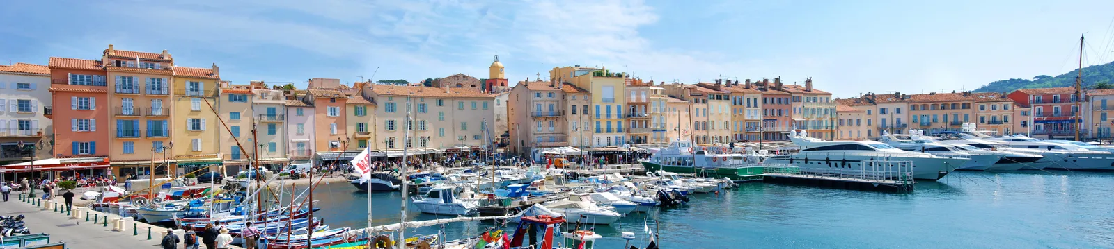 The Vieux-Port and its bell tower in a panoramic view, traditional fishing boats in the foreground
