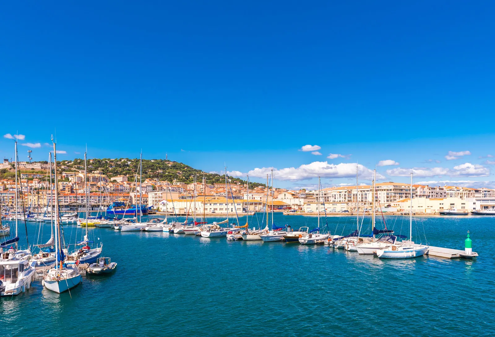 The marina of Sète, its moored yachts and the quayside façades at the foot of Mont Saint-Clair