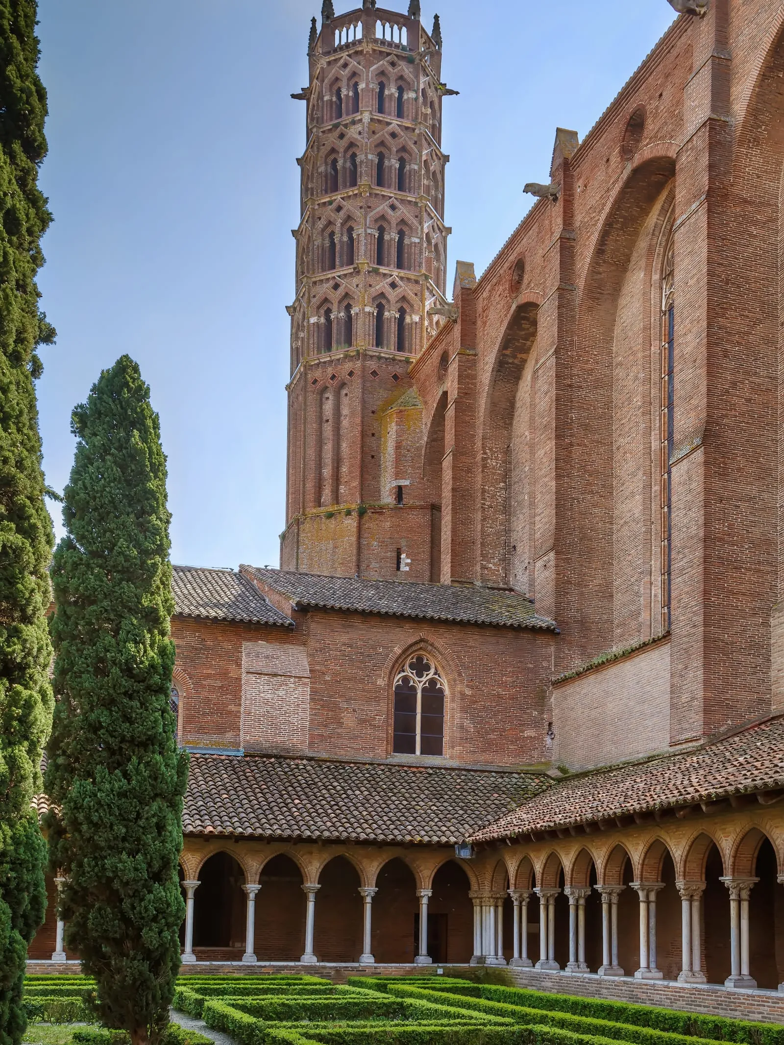 A brick church and its cypress trees