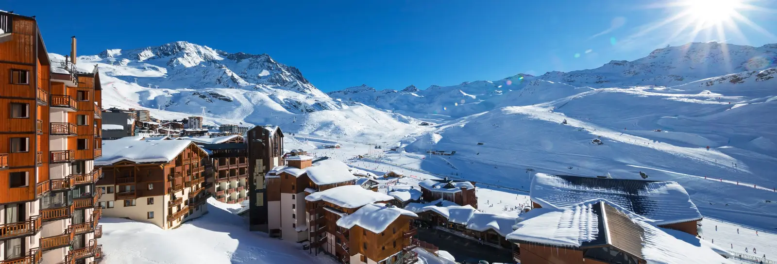 The residences and slopes of Val Thorens under snow, in the sun