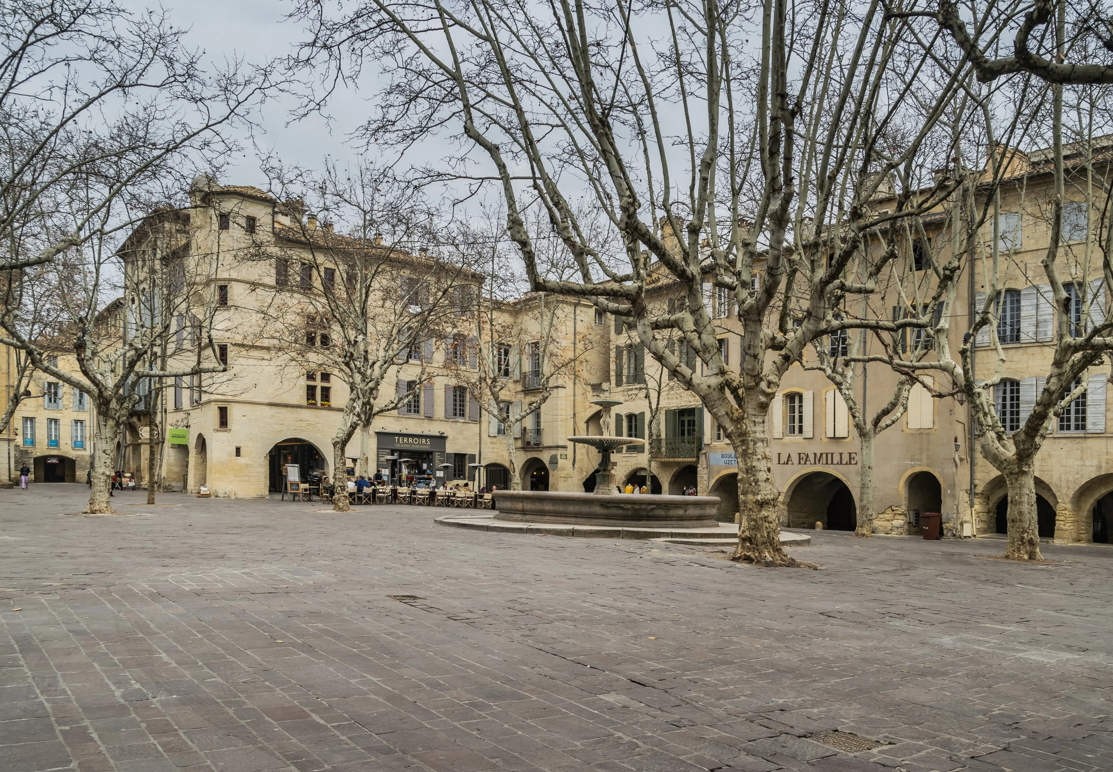 The place aux Herbes of Uzès, its arcades and plane trees