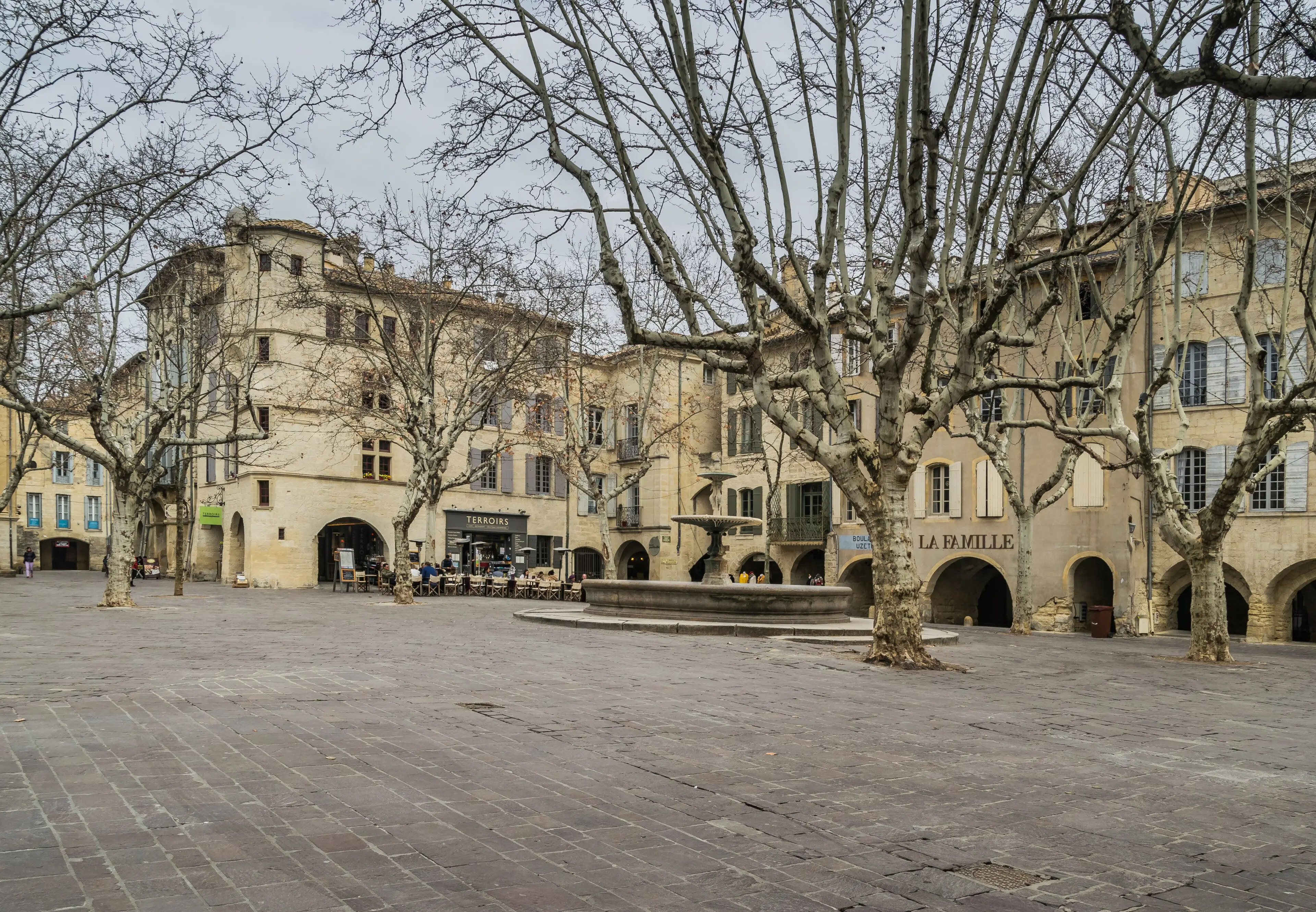 The place aux Herbes of Uzès, its arcades and plane trees